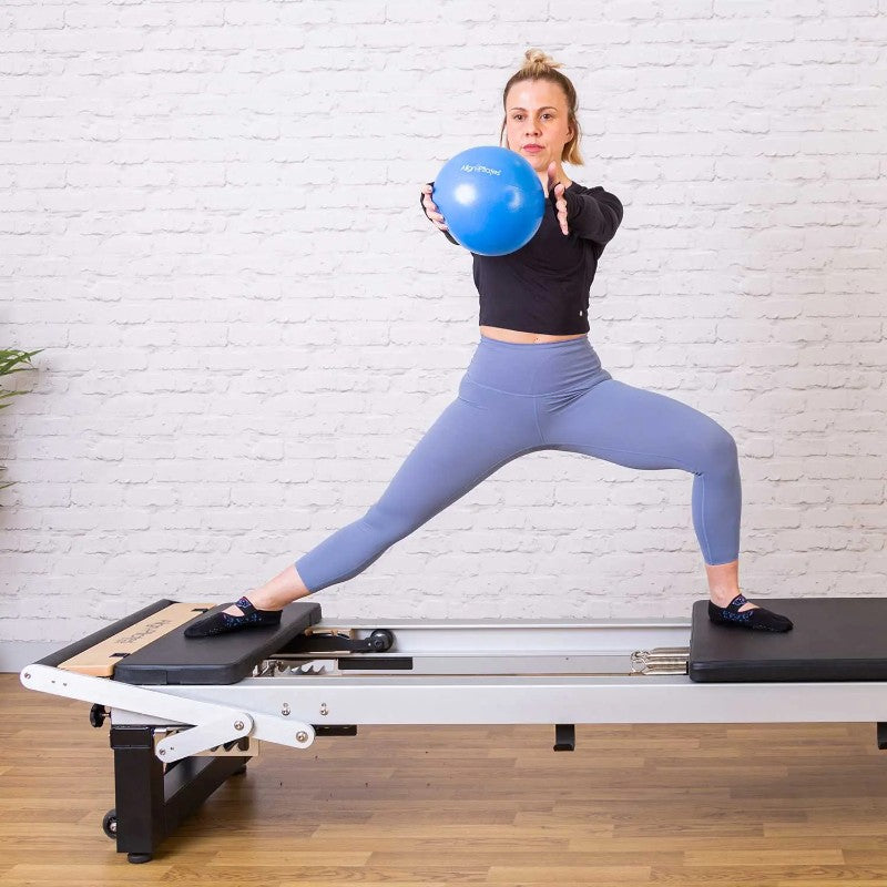 Align-Pilates Platform Extender For A-Series Reformer model standing on platform exercise