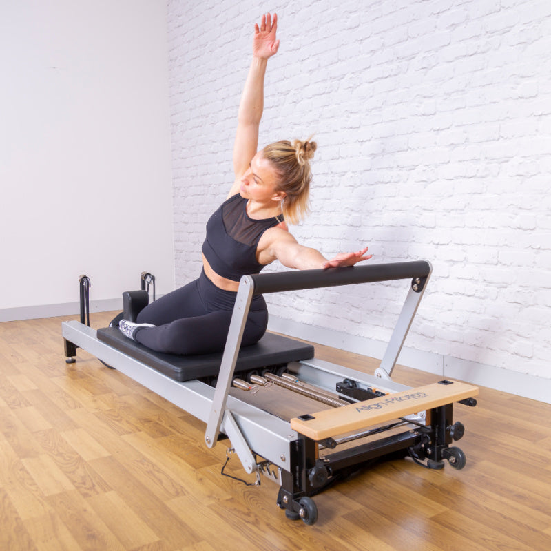 Align-Pilates C8-Pro Reformer Model Posing Diagonal View