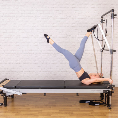 Products Align-Pilates C8-Pro Pilates Reformer With Half Cadillac push through bar pose side view