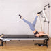 Products Align-Pilates C8-Pro Pilates Reformer With Half Cadillac push through bar pose side view