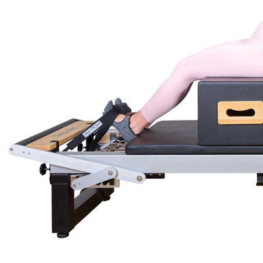 Align-Pilates Silent Pilates Reformer Foot Strap with reformer and feet side view white background
