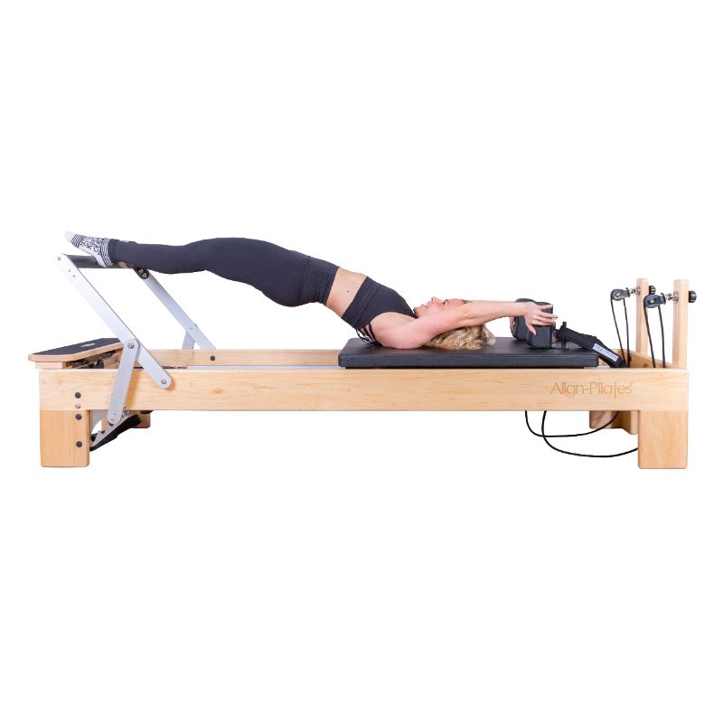 Align-Pilates-M8-Pro-Pilates-Reformer-side-view-with-model