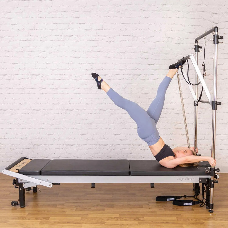 Align-Pilates Mattress Converter C-Series Model with platform extender reformer and tower from side view with brick background