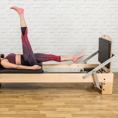 Align-pilates M8-Pro Jump Board-with-Reformer brick wall background