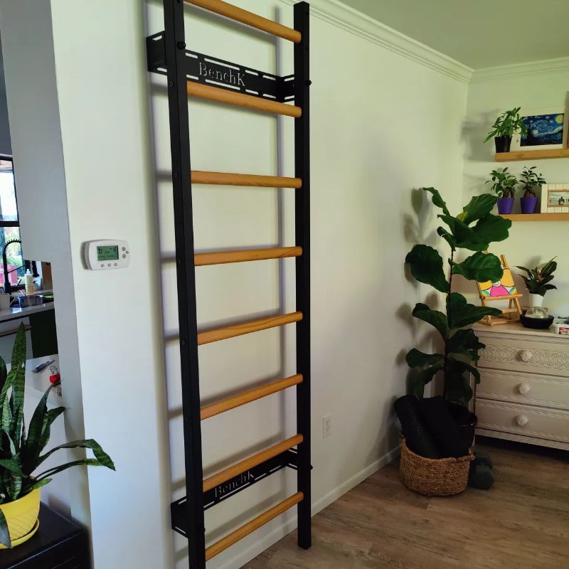 BenchK Wall Bracket for Steel Swedish Ladder in black attached to ladder in room