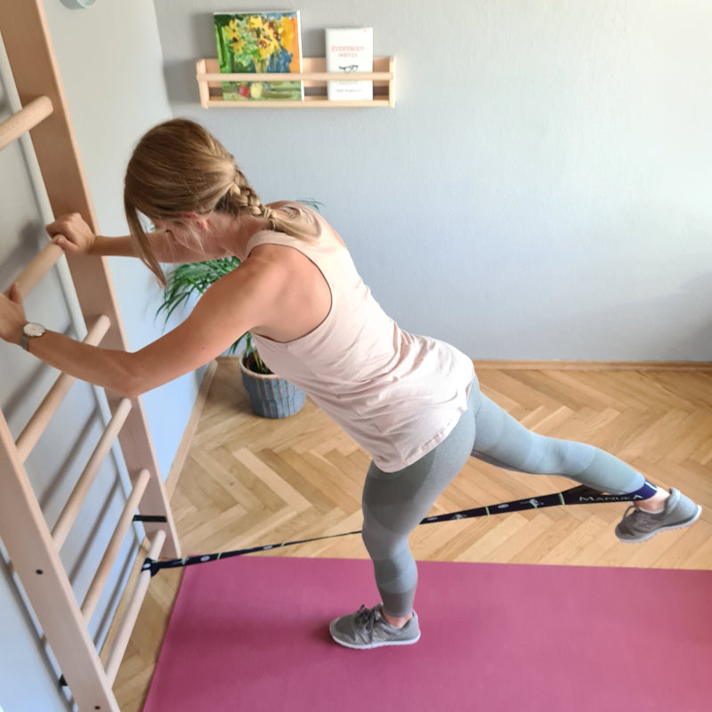 BenchK Wood Swedish Ladder with Pull Up Bar with Model Doing Band Work