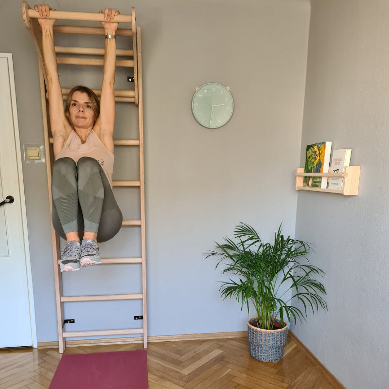 BenchK Wood Swedish Ladder with Pull Up Bar Model Doing Leg Raises Front Facing