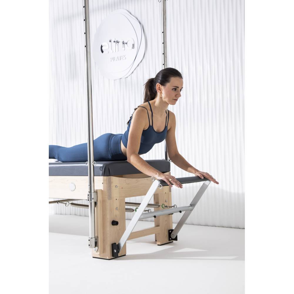 Elina Pilates Elite Cadillac Reformer grey upholstery model in studio close up