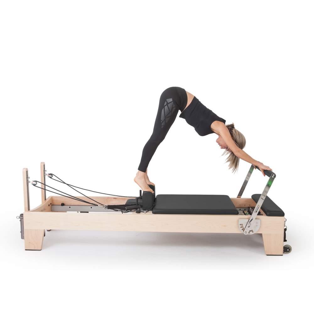 Elina Pilates Elite Wood Reformer Black Upholstery model side view Pike position-white-background