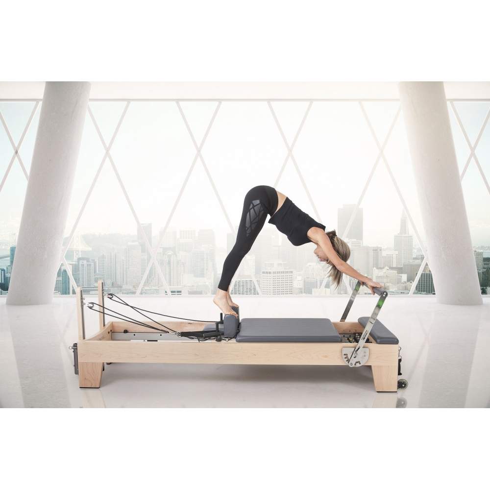 Elina Pilates Elite Wood Reformer With Tower grey upholstery model in pike position