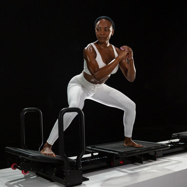 Lagree Fitness Miniformer exercises model toning diagonal view black background
