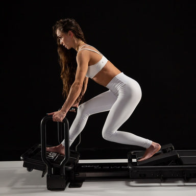 Lagree Mini Pro Miniformer lifestyle model exercising facing left