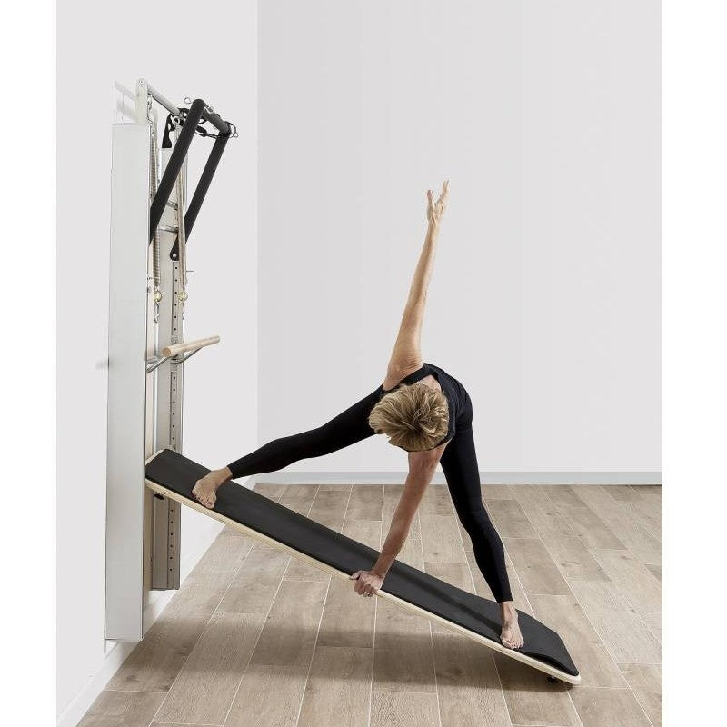 Elina Pilates Wall Board ONNE by eva espuelas fully equipped with ballet bar and mat table exercising side view