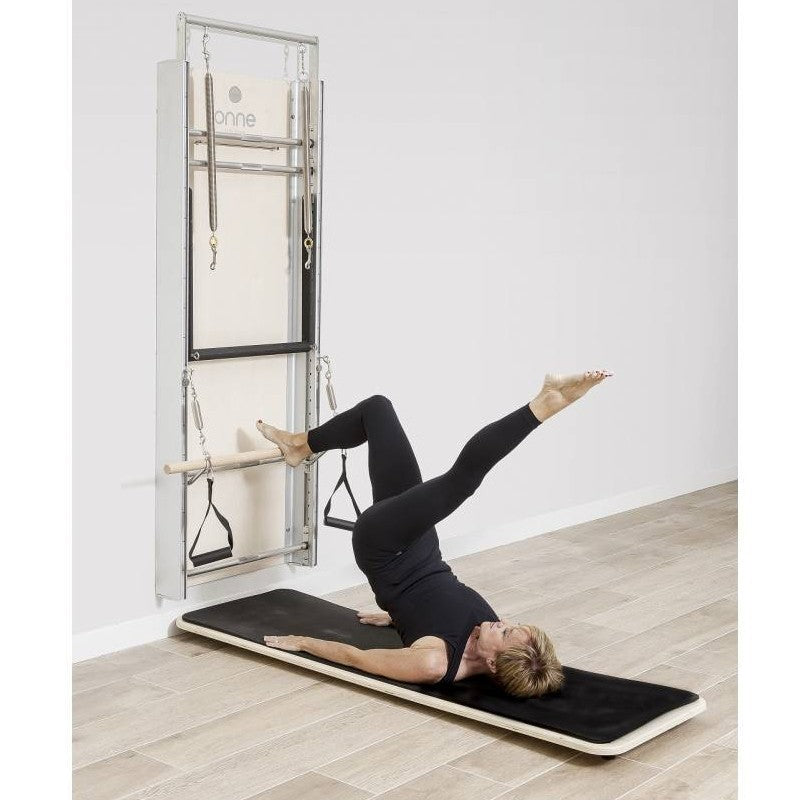 Elina Pilates Wall Board ONNE by eva espuelas fully equipped with ballet bar and mat table flat legs split diagonal view