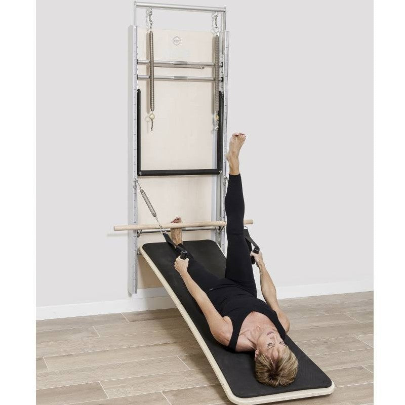 Elina Pilates Wall Board ONNE by eva espuelas fully equipped with ballet bar and mat table holding handles lying down exercise