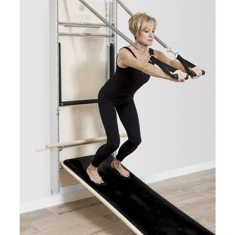 Elina Pilates Wall Board ONNE by eva espuelas fully equipped with ballet bar and mat table standing on mat table spring cables